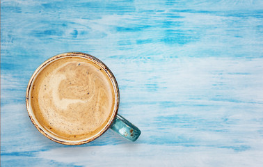 Cup of coffee with milk on wood table background