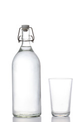 plastic free concept:  glass water bottle and water glass isolated on white background with clipping path and copy space for your text