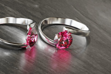 Couple of Ruby Diamond Ring Placed on Glossy background, 3D rendering.