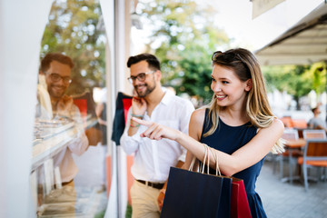 Fototapeta premium Tourist couple traveling. Travel. Walking on street. Portrait of beautiful young people