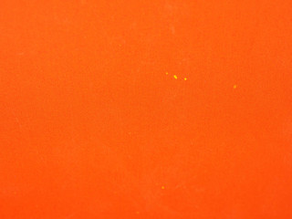 Orange colored paper background texture. Grunge image.