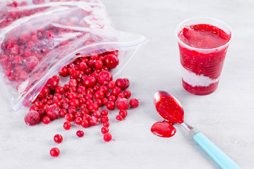 Frozen berry puree and frozen berries on white background