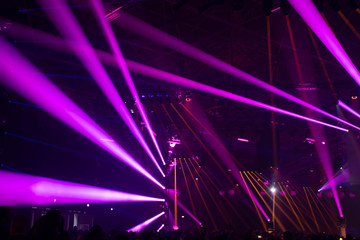 Scene, stage lights with colored spotlights and smoke, laser lights background, pink, purple, violet 