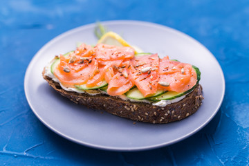 Sandwich with smoked salmon and cucumber. Concept for healthy nutrition.