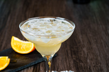 Alcoholic coktail served with orange slice close up