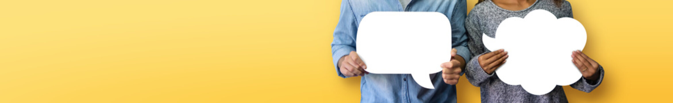 Couple holding white Speech Bubbles on yellow or orange isolated background. Banner, panoramic view for web.