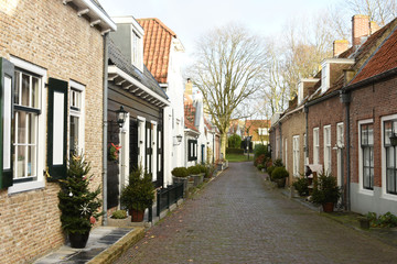 Fototapeta na wymiar small street with cobble stones in Dutch town Veere 