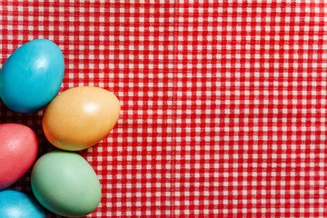Easter eggs lie on a checkered tablecloth