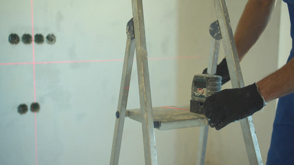 Close up, repairman works in the flat