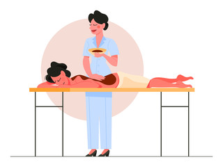 Woman making massage with chocolate for a client.