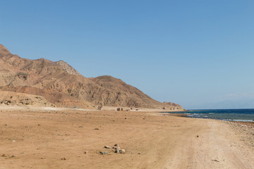 Fototapeta na wymiar The coastline of the Red Sea and the mountains in the background. Egypt, the Sinai Peninsula.