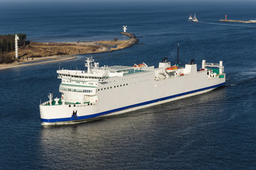 PASSENGER FERRY - The white ship flows through port channel to terminal