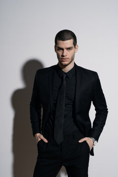 Young handsome businessman in black shirt and black suit