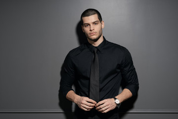 Young handsome businessman in black shirt