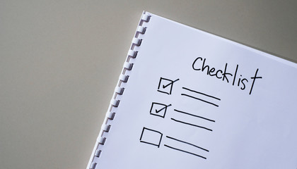 Checklist box on paper with checkmark.	