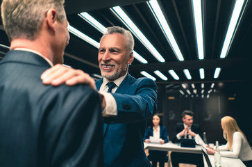 The businessmen handshaking each other