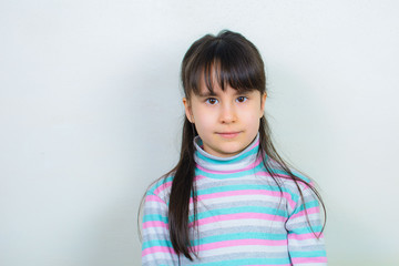 portrait of a child. Nice girl with long hair. Gray background