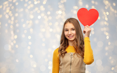 valentine's day, love and people concept - smiling young teenage girl with red heart over festive...