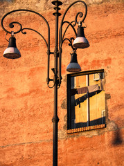 Roman broken facade with street lamps  and clothes hung out to dry