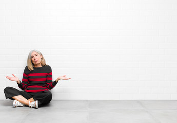 senior or middle age pretty woman feeling puzzled and confused, unsure about the correct answer or...