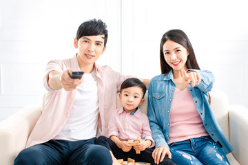 happy family watching the tv  on sofa