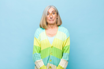 senior or middle age pretty woman feeling sad and stressed, upset because of a bad surprise, with a...
