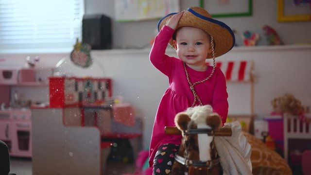 little girl playing on rocking horse