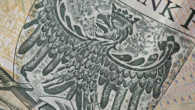 Polish zloty banknote with eagle picture close up. Poland coat of arms. Currency background.