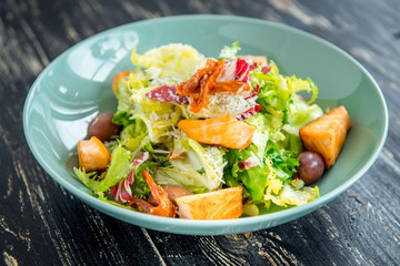 Green and healthy food salmon salad. Against a dark background