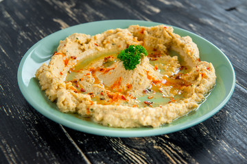 Hummus traditional Jewish creamy lunch salad with chickpeas, olive oil and paprika.