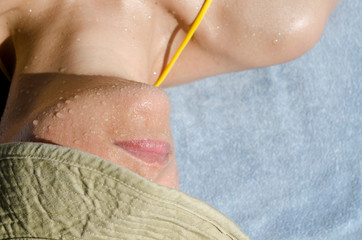 Fototapeta premium Close up on a Woman Sunbathing with Water Drops on Her Face.