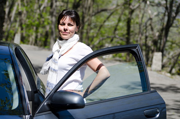 Elegant and Proud Woman Standing Close to a Car.