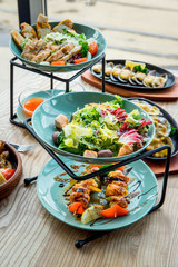 Different dishes on the table in a cafe, restaurant interior