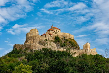 Fototapeta na wymiar Beautiful view of the Rupea Stronghold Fortress on a blue sky with white clouds, Rupea, Brasov, Romania