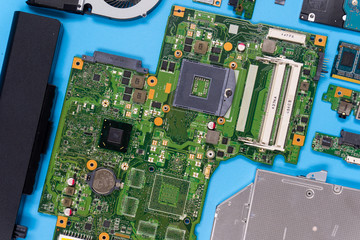 Parts of a modern computer. The insides of a laptop on a blue background, flat lay composition