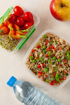 Trendy lunch with rice and vegetables. Served in a portable box on a bright painted background. Perfect for work or school. Top view.