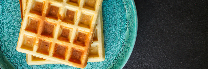 Belgian or Viennese waffles (delicious sweet dish, dessert snack) menu concept. background. top view. copy space
