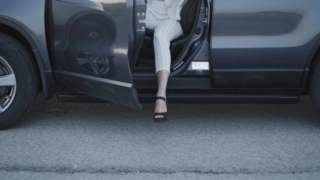 Low View Of Woman In High Heel Shoes Getting Out From The Car