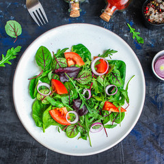 Healthy salad, leaves mix salad (mix micro greens, cucumber, tomato, onion, other ingredients). food background. copy space