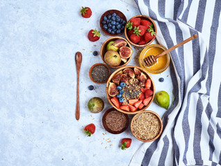 Healthy breakfast and breakfast ingredients, oatmeal with fruits and berries, figs, blueberries,...