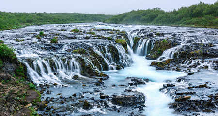 Panoramical view of famous Bruarfoss waterfall with blue water in summer time. Iceland, Europe