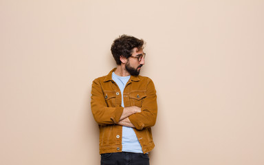young cool and crazy man against flat wall
