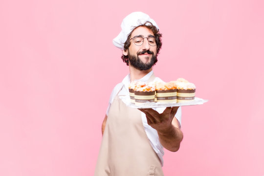 Young Crazy Baker Man Confectionery Concept Against Pink Wall