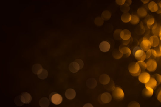 Abstract golden and black backdrop with bokeh