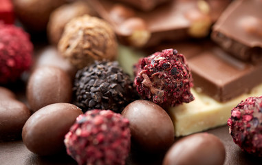sweets, confectionery and food concept - close up of different chocolate candies