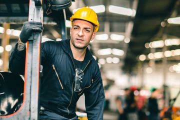 Portrait of Caucasian factory worker handsome smart with safety clothes and yellow helmet.