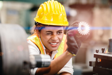 engineer worker looking at steel gear part, working precise and most accuracy high performance...