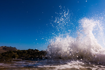 A surge of surf waves on a rocky shore