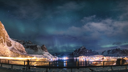 Aurora borealis on Reine village with snowy mountain in Lofoten Islands, Norway