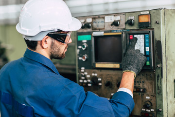 factory worker man operate the machine, high skill labor work industry with safety clothes.